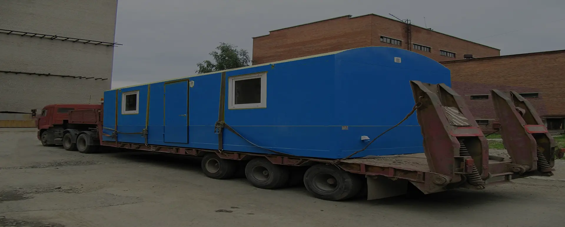 Заказать безопасную и качественную перевозку вагон домов и блок комнат по России из Волгограда специализированными низкорамными тралами